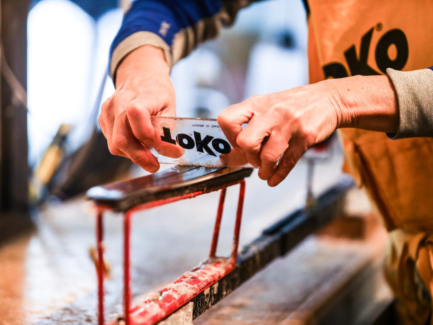 skis getting waxed in rental shop