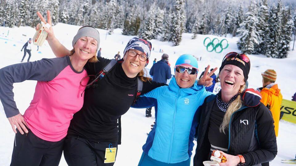 Group of people smiling at a winter sport facility