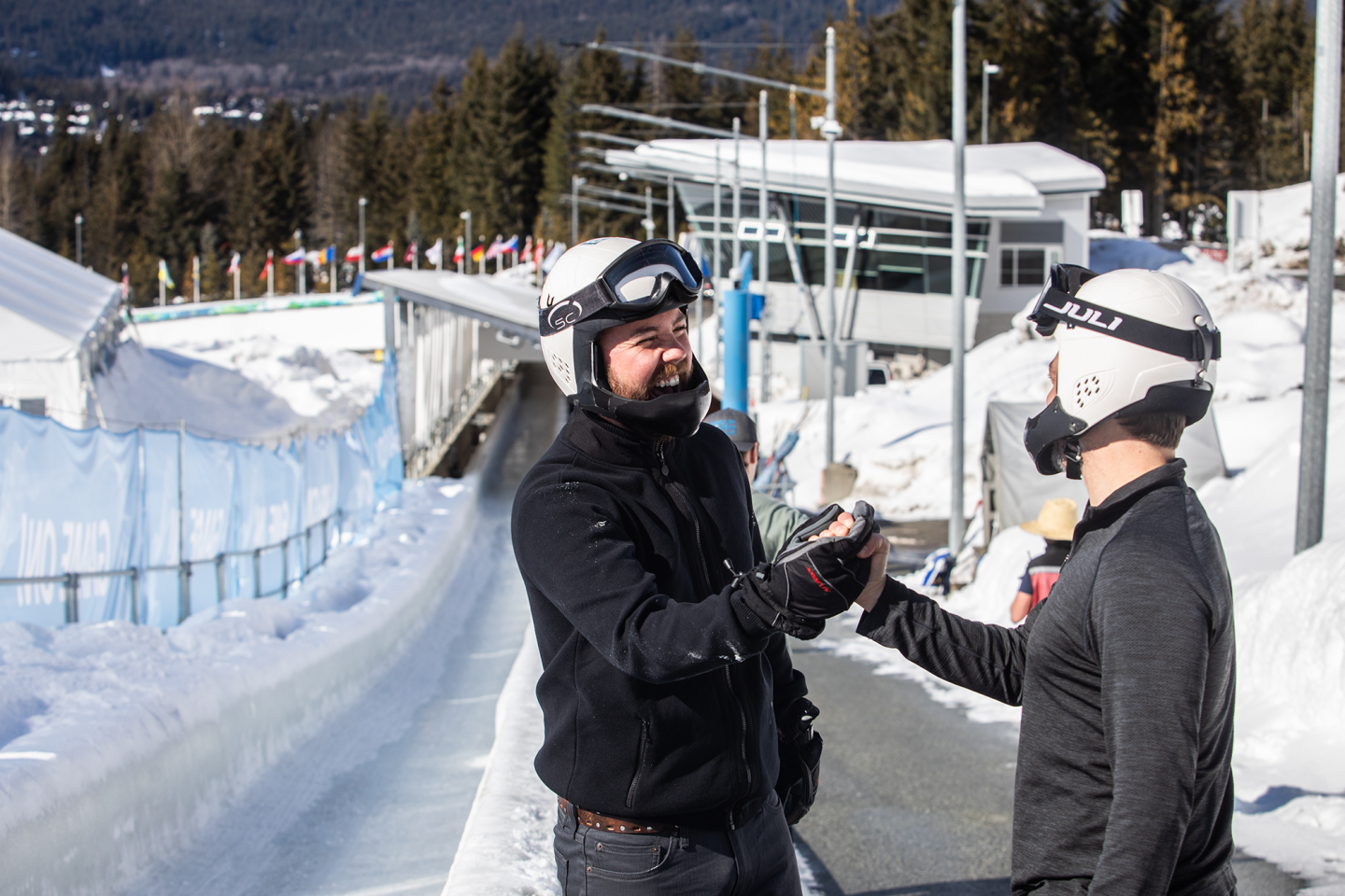 two participants shaking hands beside track